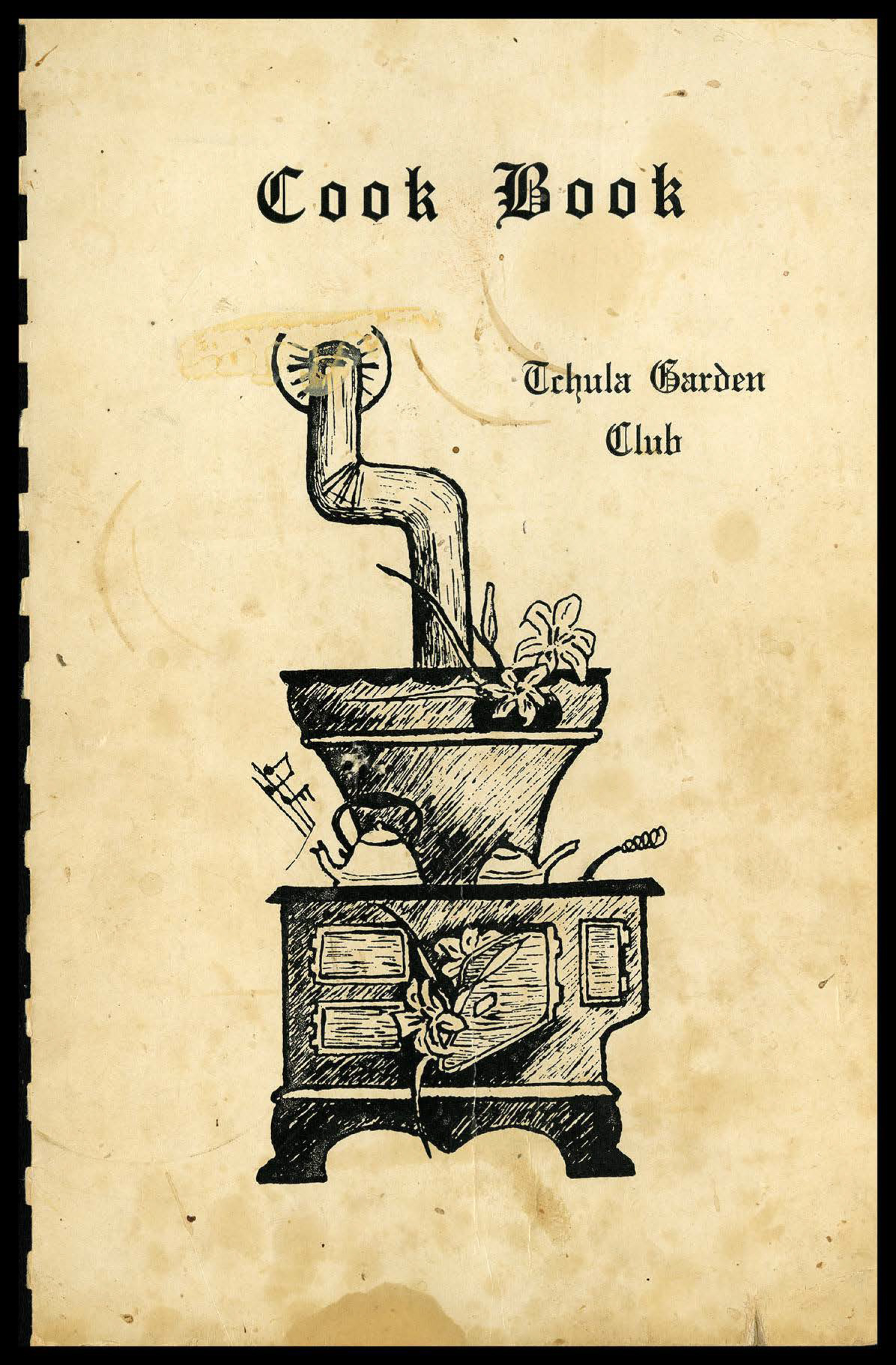 A yellowed piece of paper with a plastic ring binding. On it is a hand-drawn image of a wood stove and the text “Cook Book Tchula Garden Club” printed in a gothic blackletter.